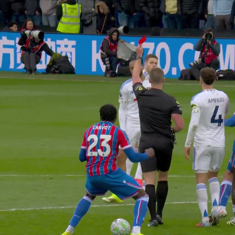 Jaydee Canvot reacts as a referee shows a red card to a player on the opposing team.