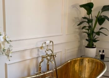 Millie Mackintosh's extensive renovation of her £5million home includes a large, sprawling bathroom fit with high ceilings, a copper bath tub and a spot of greenery