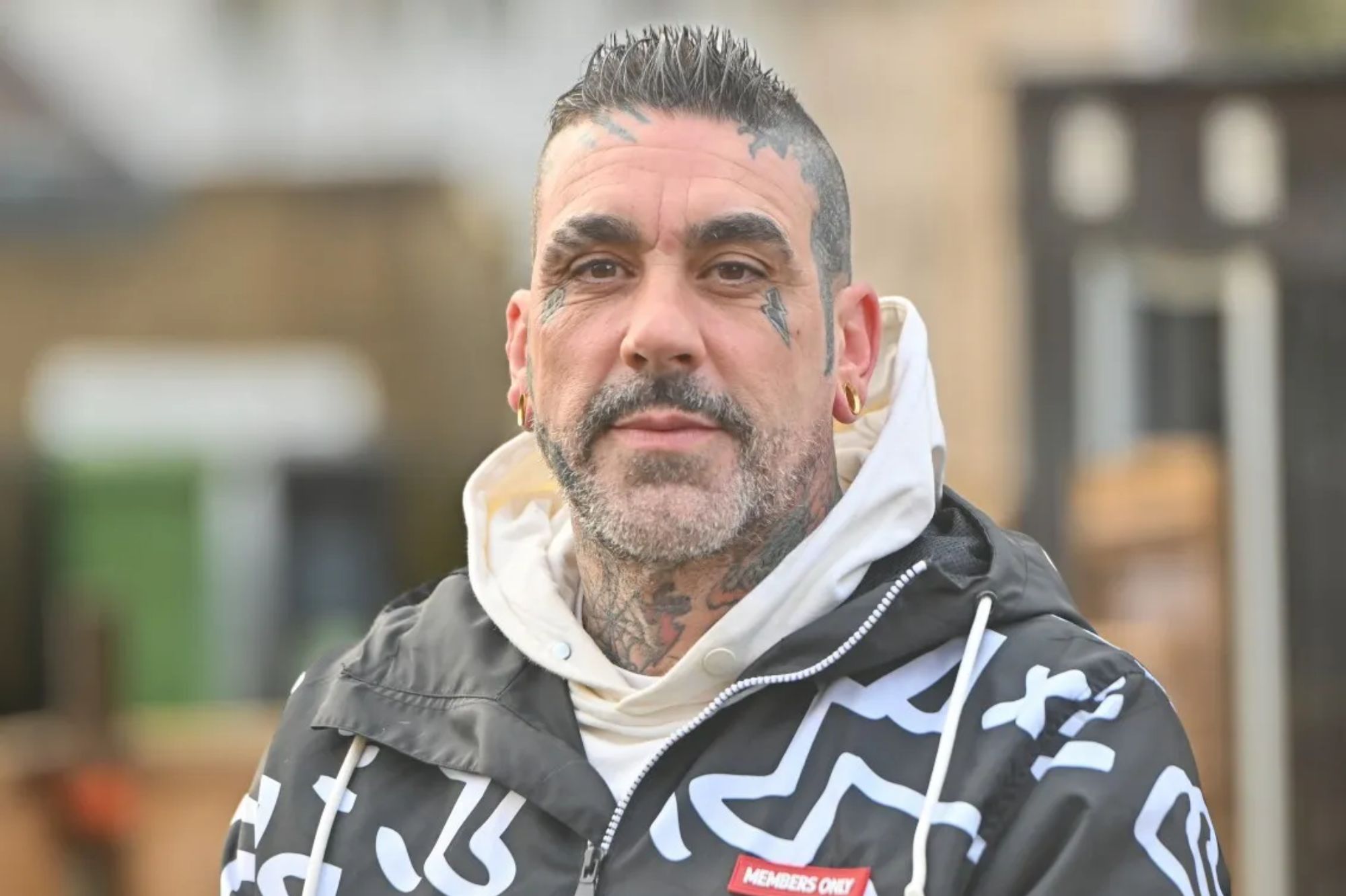 An image collage containing 1 images, Image 1 shows Reality TV contestant SNHMO, with tattoos on his face and neck, looks at the camera