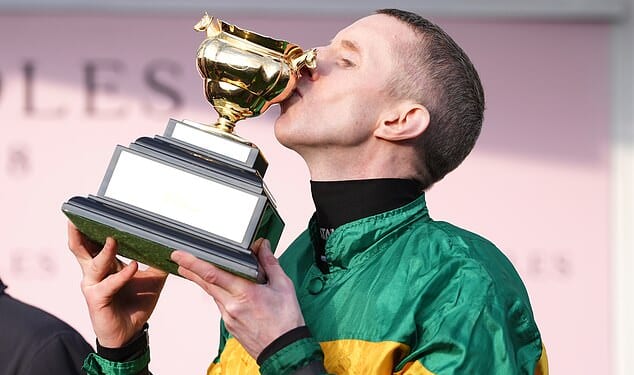 Mark Walsh celebrates with the Cheltenham Gold Cup trophy after winning the Boodles Cheltenham Gold Cup Chase with Inothewayurthinkin on day four of the 2025 Cheltenham Festival at Cheltenham Racecourse. Picture date: Friday March 14, 2025. PA Photo. See PA story RACING Cheltenham. Photo credit should read: Adam Davy/PA Wire.RESTRICTIONS: Use subject to restrictions. Editorial use only, no commercial use without prior consent from rights holder.