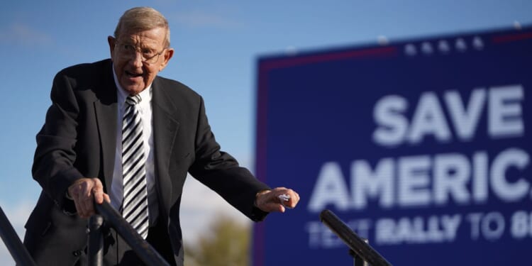 Lou Holtz leaves the stage during a rally with President Donald Trump at the Florence Regional Airport on March 12, 2022, in Florence, South Carolina.