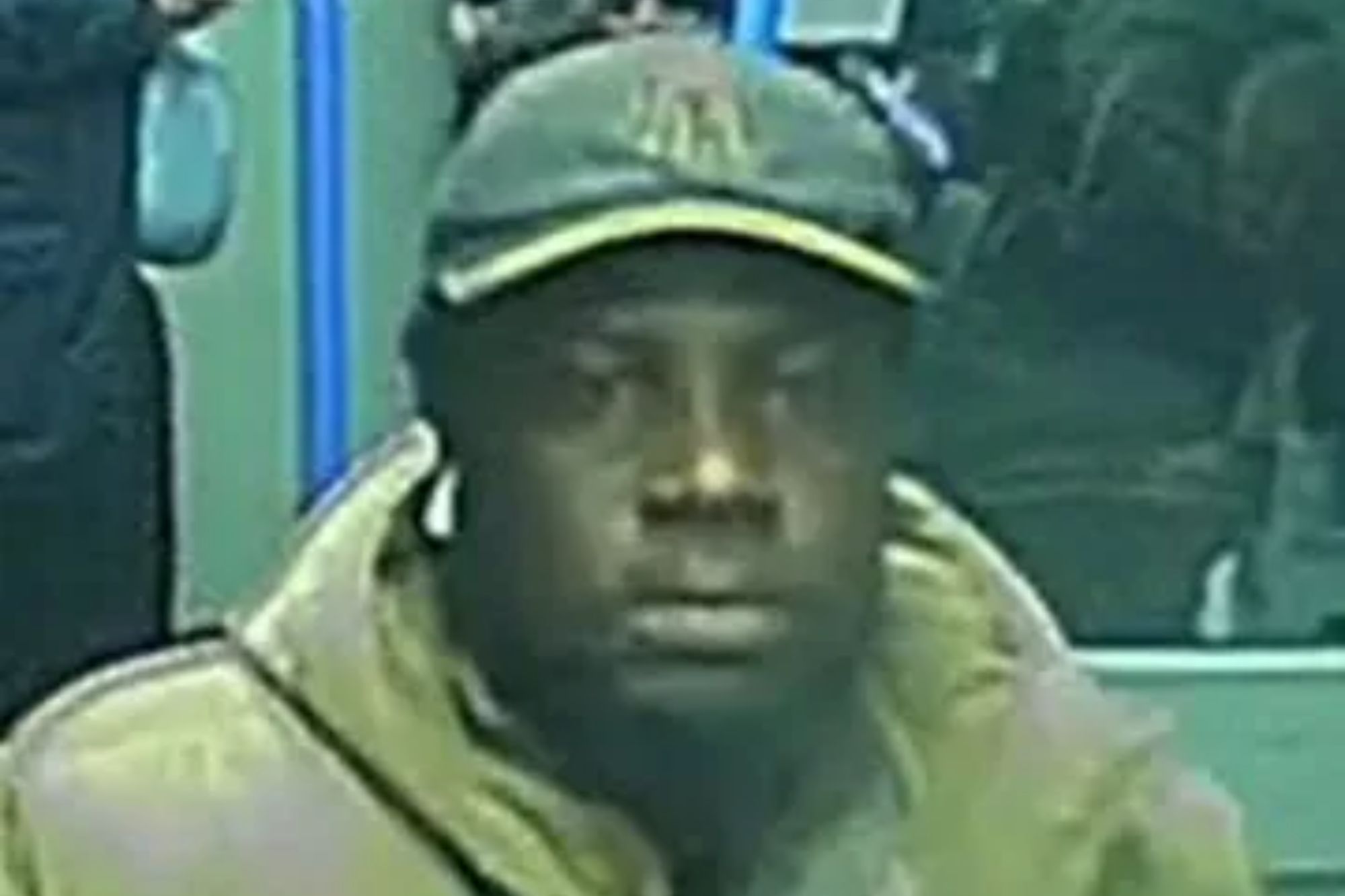 An image collage containing 1 images, Image 1 shows CCTV image of a man in a puffy jacket and baseball cap