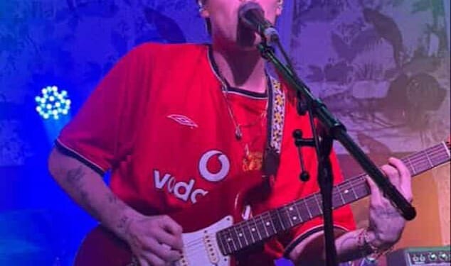 Cruz Beckham rocked a Manchester United football shirt in honour of his father David, who turned up to support him as he took his tour to the city on Wednesday