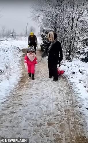 The cyclist approaches the girl on the icy path