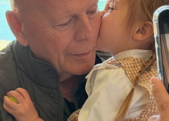 The Die Hard actor could be seen holding his granddaughter Louetta, nearly three, as she placed a kiss on his cheek