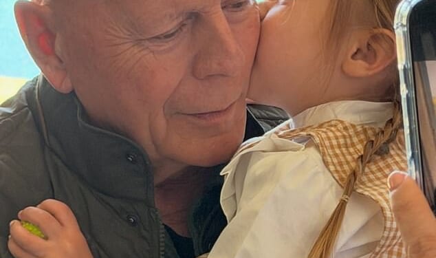 The Die Hard actor could be seen holding his granddaughter Louetta, nearly three, as she placed a kiss on his cheek