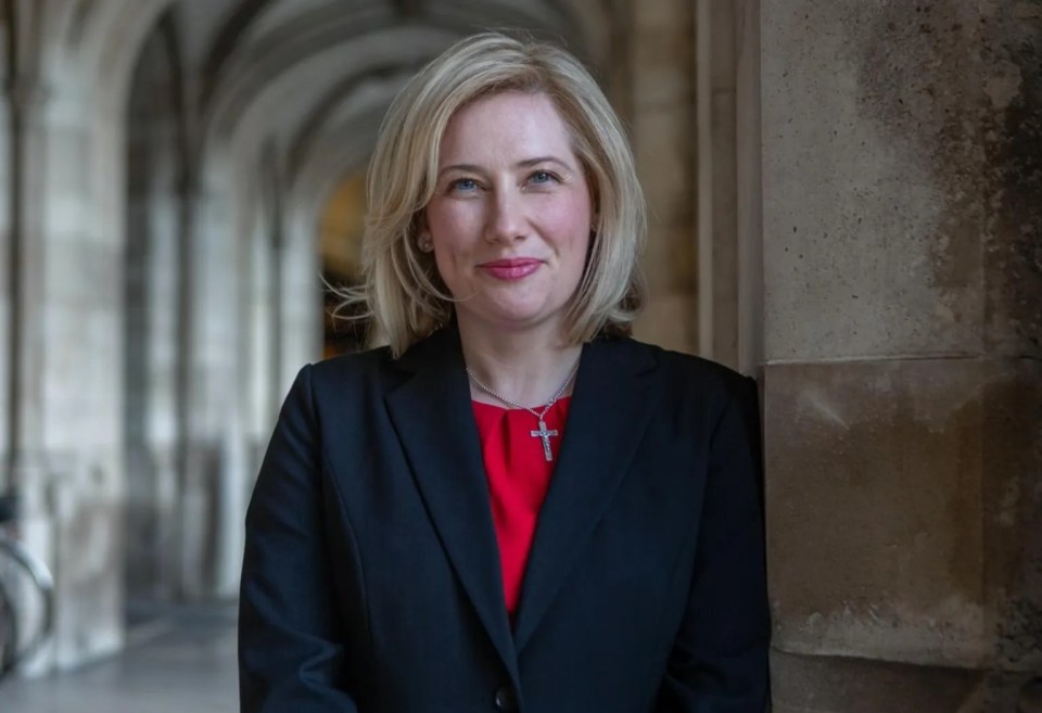 Emma Lewell-Buck, MP, stands in an arched hallway.