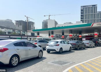 Cars queue outside a petrol station in Dubai after attacks on Iran began, with the Iranians then striking the emirate. Some have chosen to flee by road