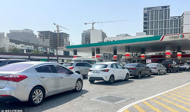 Cars queue outside a petrol station in Dubai after attacks on Iran began, with the Iranians then striking the emirate. Some have chosen to flee by road