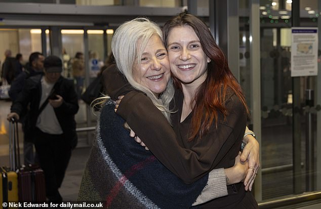 Isabel Robertson (pictured), 29, of Windsor was greeted with a hug from mother Alba as she landed on Monday