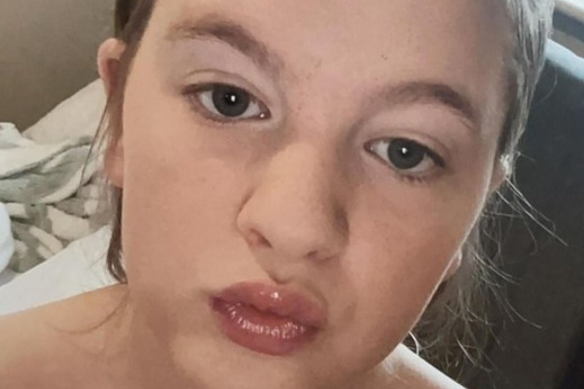 An image collage containing 1 images, Image 1 shows Close-up photo of Falon, a 12-year-old girl with light brown hair pulled up, light brown eyebrows, a light complexion, and red lips, making a kissing face