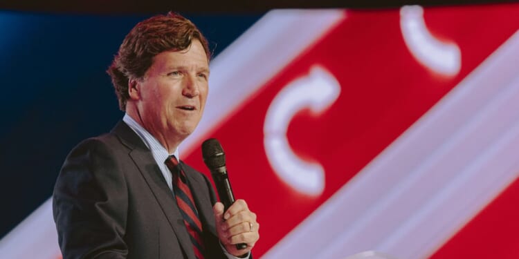 Tucker Carlson speaks at Turning Point USA's annual AmericaFest conference, in remembrance of late conservative political activist Charlie Kirk, in Phoenix, Arizona, on Dec. 18, 2025.