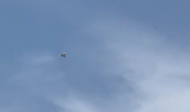 An Iranian Shahed-136 attack drone flies over Al Mamzar Beach in Dubai moments before it is intercepted by the UAE