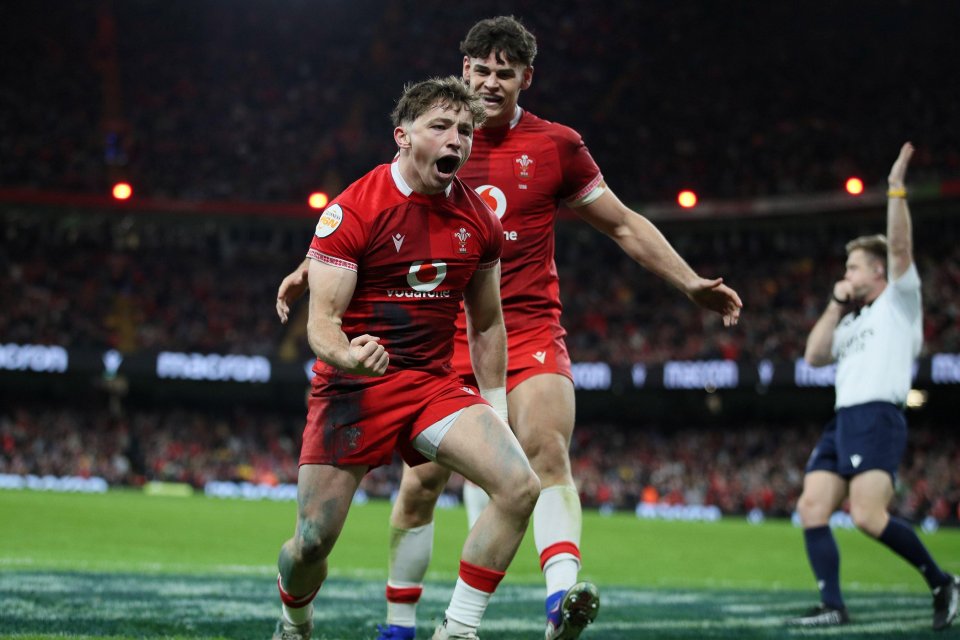 Dan Edwards of Wales celebrates scoring a try with his teammate.