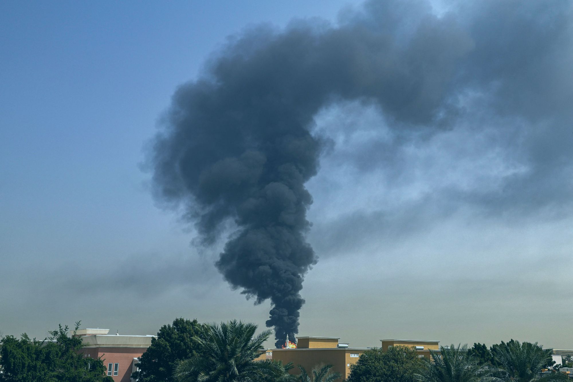 An image collage containing 1 images, Image 1 shows A large plume of dark smoke rises from a fire at Dubai International Airport