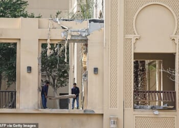 Workers clean debris from damage caused by an Iranian strike at the Fairmont hotel in Dubai on March 2