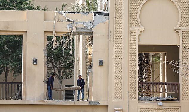 Workers clean debris from damage caused by an Iranian strike at the Fairmont hotel in Dubai on March 2