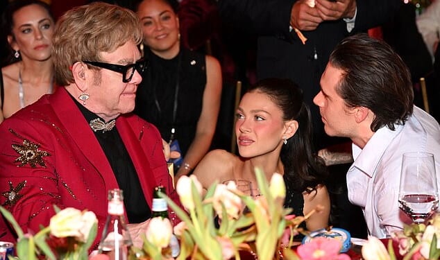 Elton John looked to be playing mediator between his godson Brooklyn Beckham and his superstar family at his Oscars viewing party on Sunday