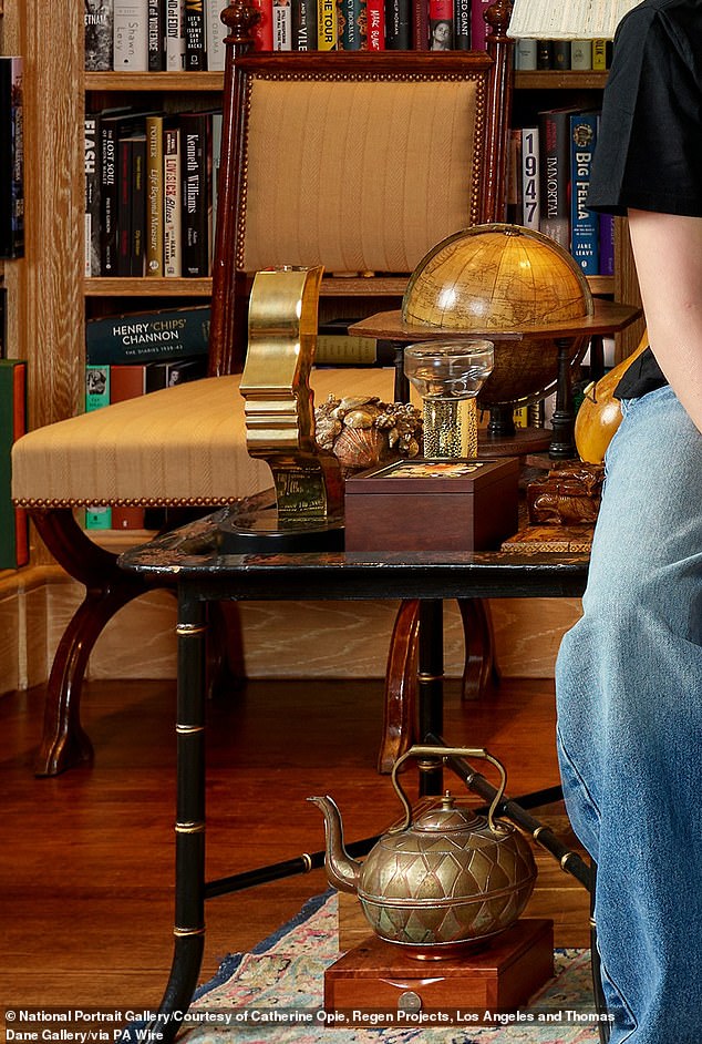 At one side of the library sat a copper teapot, a £152 diffuser as well as a desk globe and a TV award, pictured