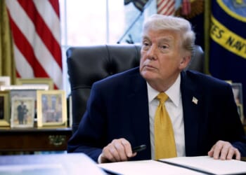 President Donald Trump prepares to sign paperwork during a White House signing ceremony in the Oval Office on March 16, 2026, in Washington, D.C.