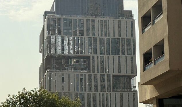 A damaged building in DIFC Dubai, after debris from a successful interception caused minor damage to the facade, amid the U.S.-Israeli conflict with Iran, in Dubai, United Arab Emirates, March 13, 2026. Picture taken with a mobile phone. REUTERS/Stringer