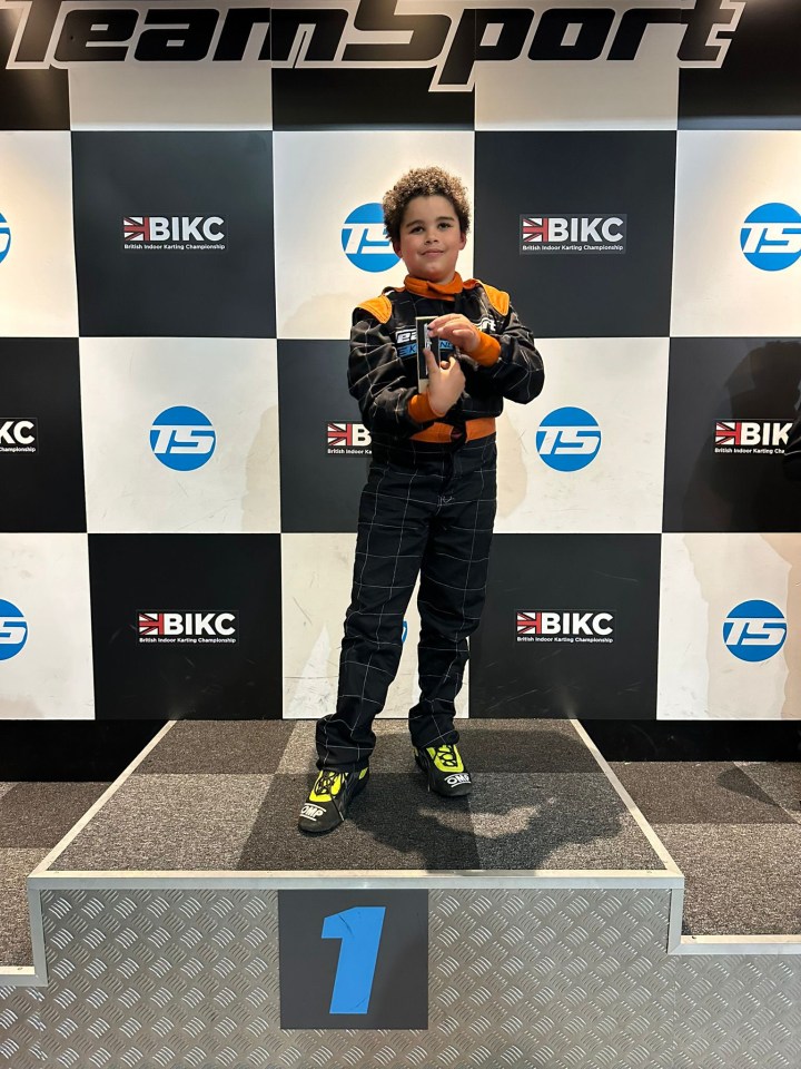 12-year-old Theo Bobb on a first-place podium at the British Indoor Karting Championship.
