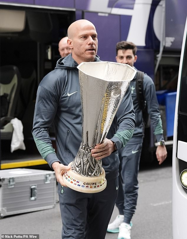 Dixon is Tottenham's player liaison officer - pictured carrying the Europa League trophy