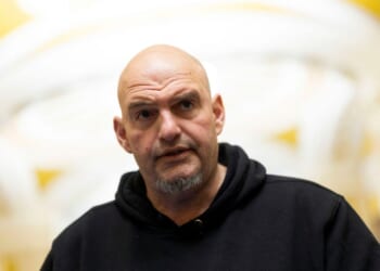 Sen. John Fetterman speaks to reporters as he leaves the Senate Chamber at the U.S. Capitol on Jan. 29, 2026, in Washington, D.C.