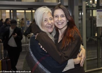 Isabel Robertson (pictured), 29, of Windsor was greeted with a hug from mother Alba as she landed on Monday