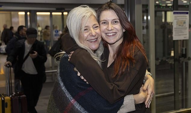 Isabel Robertson (pictured), 29, of Windsor was greeted with a hug from mother Alba as she landed on Monday
