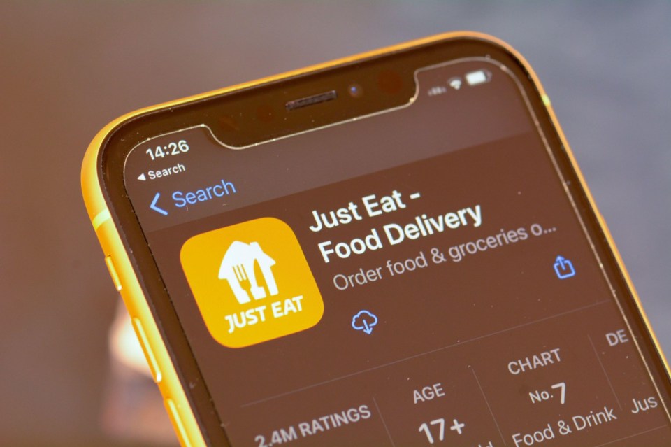 A smartphone screen displays the Just Eat food delivery app in an app store.