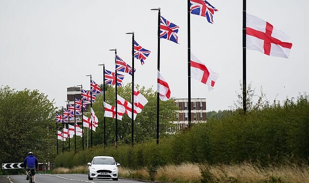 A leaked draft of the proposals suggests national symbols were sometimes used last summer to 'exclude or intimidate'. Pictured: The Union Jack flag and the Flag of St George hang from lampposts in Birmingham