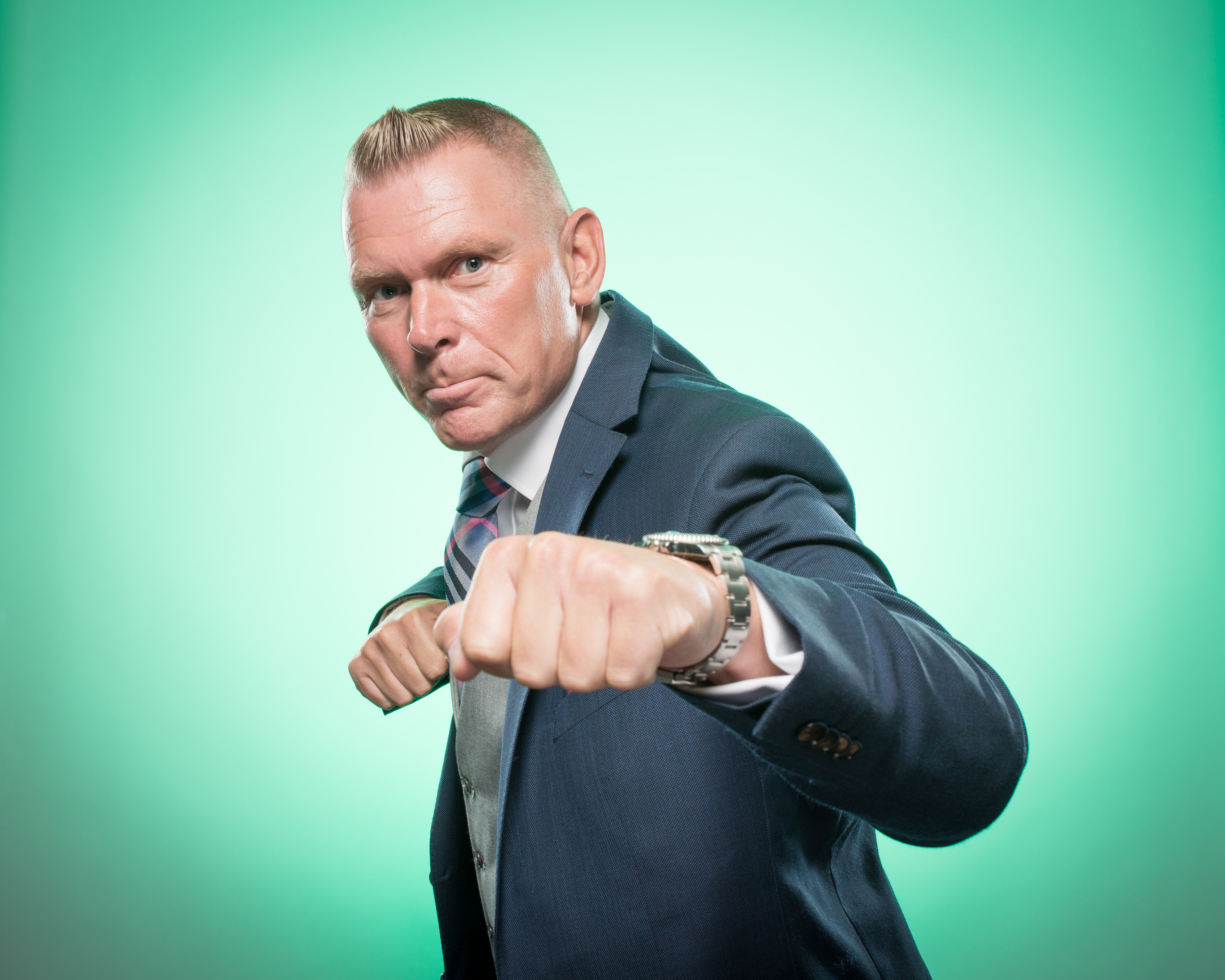 Matt Chapman in a suit, making a punching gesture.