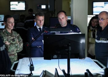 Emmanuel Macron has ordered French Navy ships to the Strait of Hormuz in an 'unprecedented' bid to combat skyrocketing oil prices (The French President, middle left, is pictured at the bridge of a warship on Monday)
