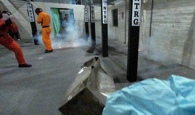 Flashbangs explode during a training exercise at the headquarters of the Operational Response and Resilience Unit (ORRU) in Kidlington, Oxfordshire