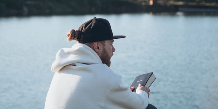 A Christian man holds a Bible in his hands.