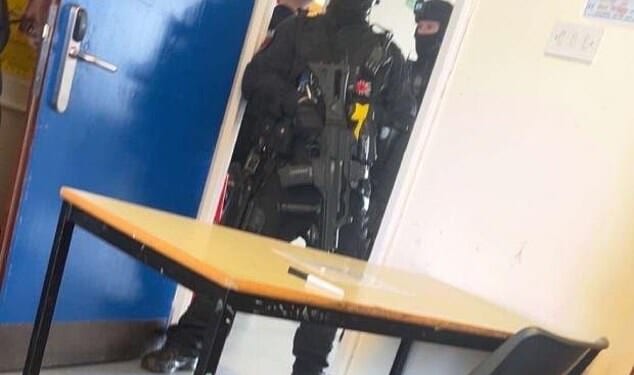 This is the moment a 15-year-old boy is arrested by armed police after a teenage girl pupil is stabbed at school