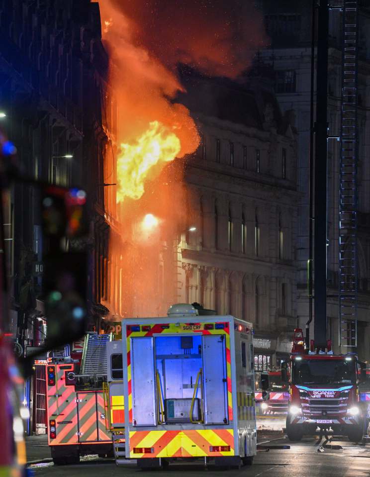 A large fire engulfs a building in Glasgow city center, with fire trucks visible in the foreground.
