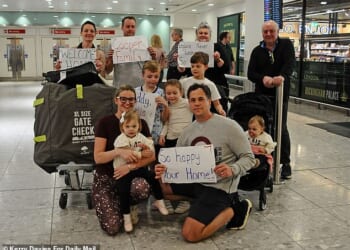 Sable and Brandon Cooper (front left and right) are given a huge welcome back by their family at London Heathrow after being caught in the middle of the attacks in Dubai