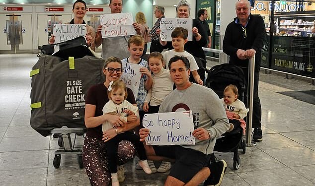 Sable and Brandon Cooper (front left and right) are given a huge welcome back by their family at London Heathrow after being caught in the middle of the attacks in Dubai