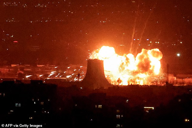 The skies over Tehran turned a haunting shade of red and filled with acrid smoke after several oil and fuel depots were blown up (Pictured: An explosion erupts following strikes near Azadi Tower close to Mehrabad International Airport in Tehran on March 7)