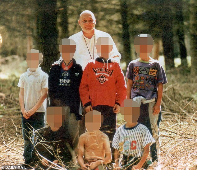 Hamilton in his role as a youth group leader, surrounded by a group of young boys