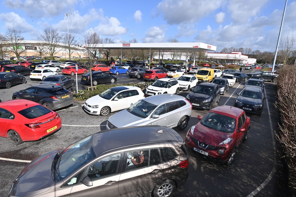A long queue of cars waiting for fuel at a Costco petrol station in Manchester.