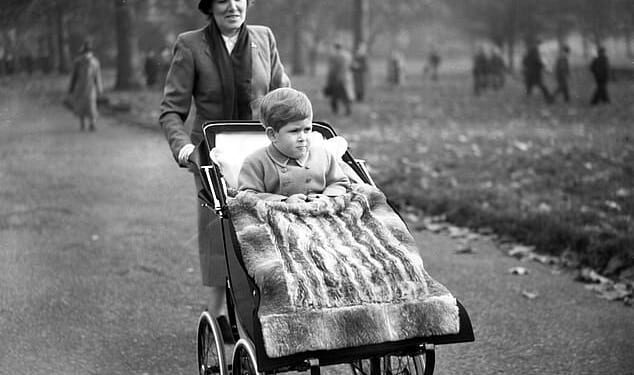 Then-Prince Charles is taken for a walk in his pram through the park on his third birthday by nanny Mabel Anderson