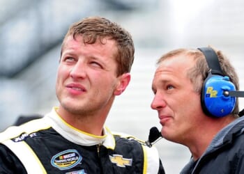 Chase Pistone, left, talks with a crew member during practice for the NASCAR Camping World Truck Series Kroger 250 at Martinsville Speedway on March 28, 2014, in Martinsville, Virginia.