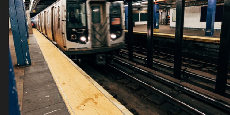A stock photo of a New York subway car arriving at a station.