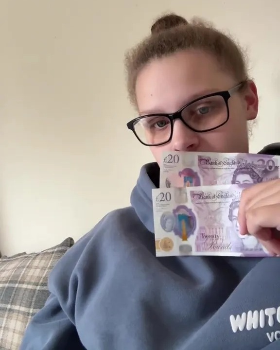 A young woman holds up fifty pounds in cash with text overlay that reads "£50 for 3 weeks with 3 kids AGAIN?!"