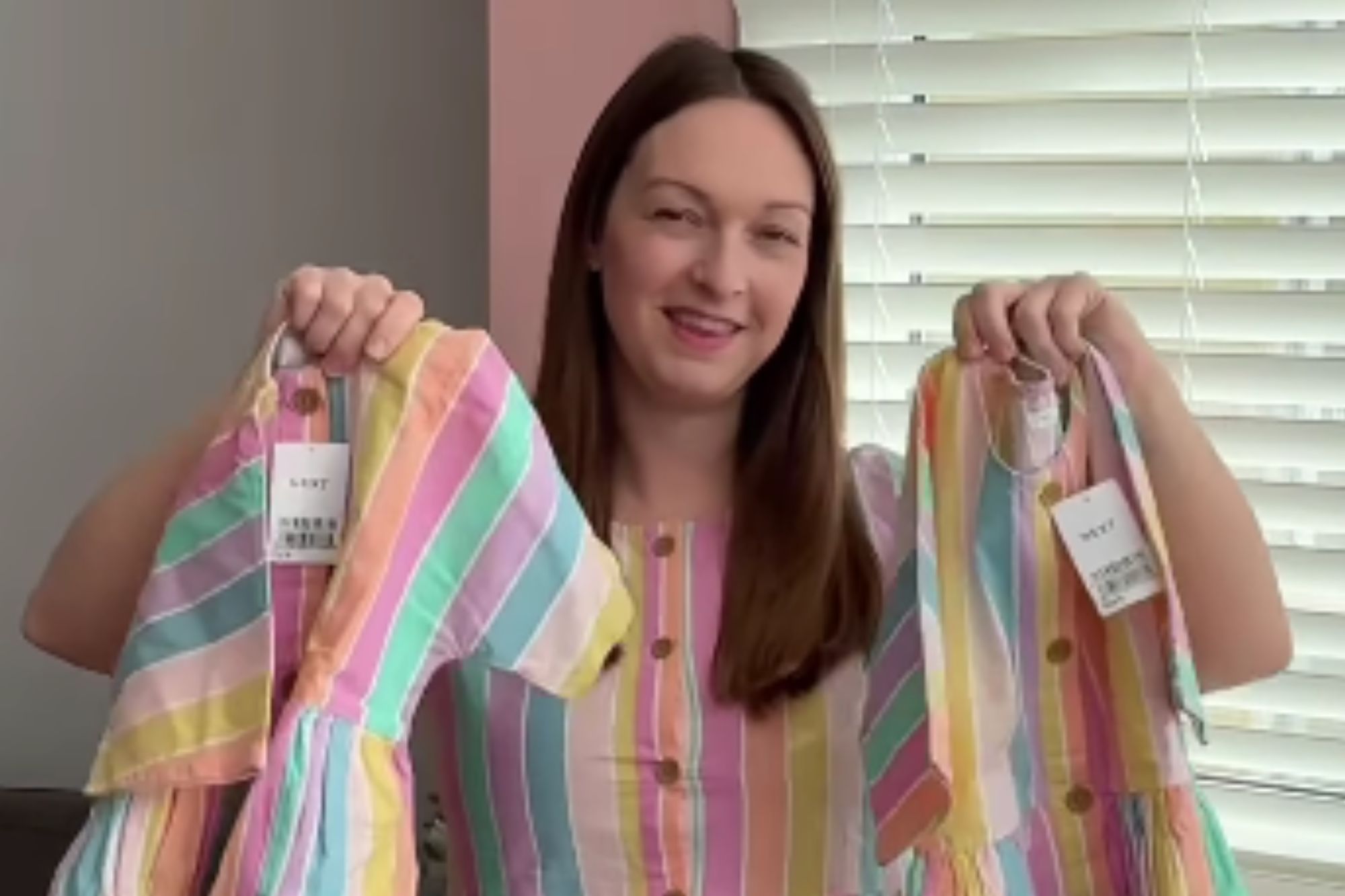 An image collage containing 1 images, Image 1 shows A woman wearing a striped dress holds up two smaller matching dresses