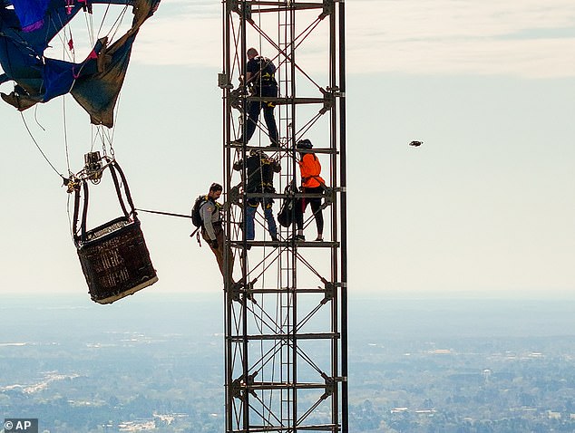 Just before 9am, firefighters began climbing the 1100-foot tower and by 10am they had reached the travelers, who were stuck at around 920 feet