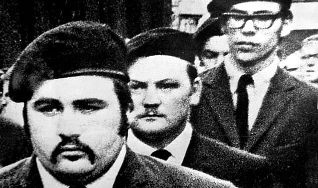 Gerry Adams (right) marches in a guard of honour' at the funeral of Provisional IRA man Michael Kane in Belfast in September 1971